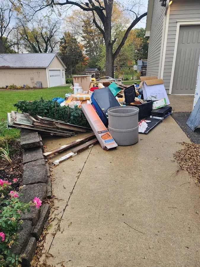 Dumpster being loaded with debris for Commercial Dumpster Rental in Ely